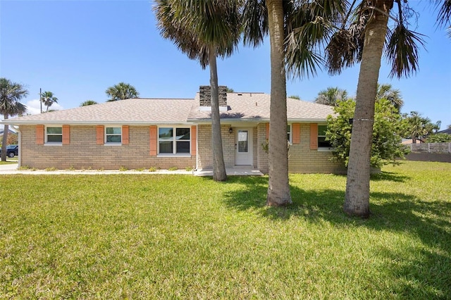 2413 S Flagler Ave, Flagler Beach, FL 32136 - ranch-style home featuring a front lawn, brick siding, and roof with shingles