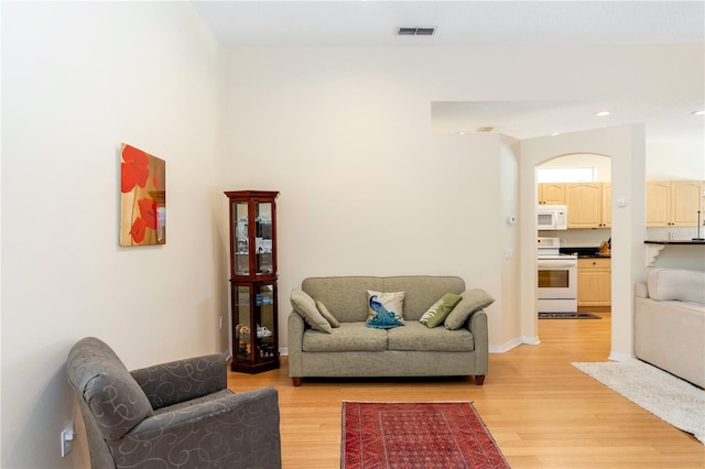 living area with recessed lighting, visible vents, and light wood-type flooring
