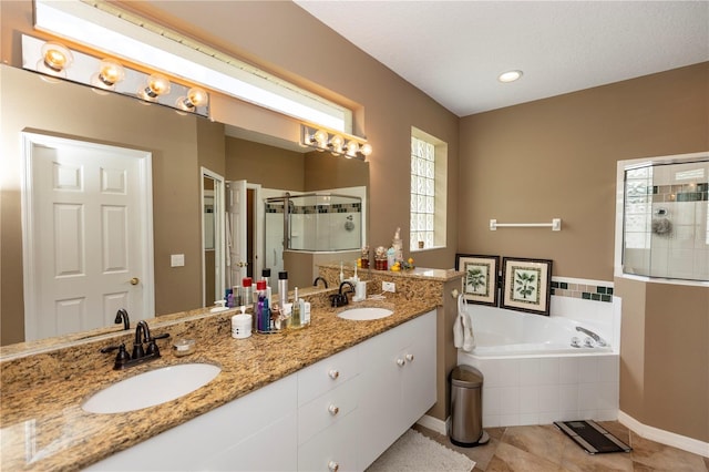 full bathroom with tile patterned floors, a sink, a bath, and a stall shower