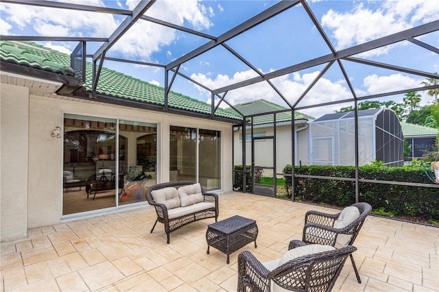 view of patio / terrace featuring an outdoor living space and glass enclosure