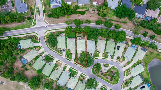 drone / aerial view featuring a water view and a residential view