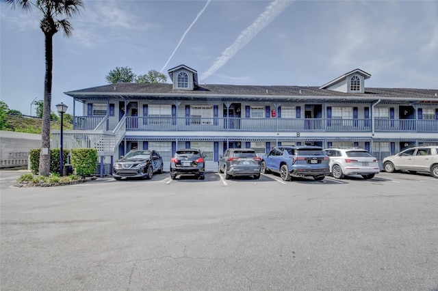 313 Dirksen Dr Unit B15, Debary, FL 32713 - view of building exterior featuring uncovered parking and stairway
