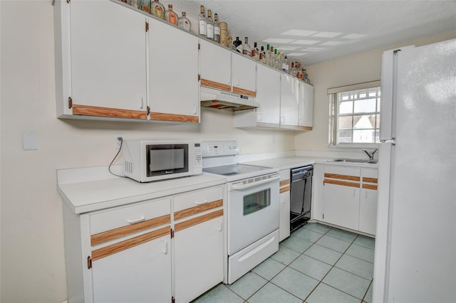 313 Dirksen Dr Unit B15, Debary, FL 32713 - kitchen with white appliances, under cabinet range hood, a sink, light countertops, and light tile patterned floors
