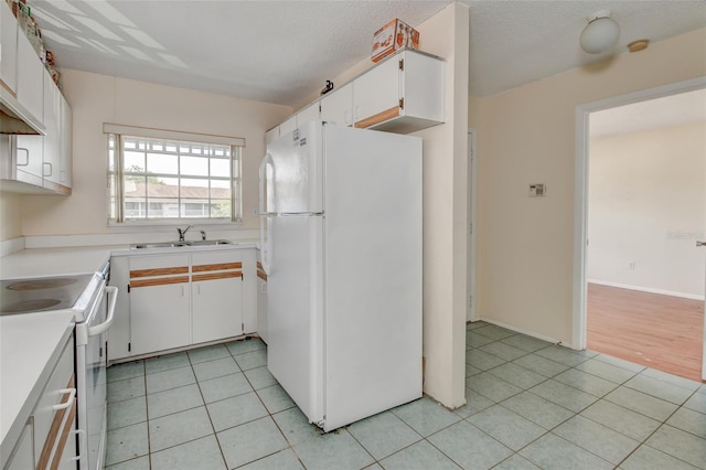 313 Dirksen Dr Unit B15, Debary, FL 32713 - kitchen with white appliances, a sink, white cabinetry, and light tile patterned flooring