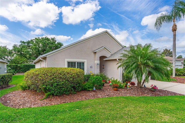 276 Gala Cir, Daytona Beach, FL 32124 - view of front facade featuring stucco siding, a front lawn, concrete driveway, and an attached garage