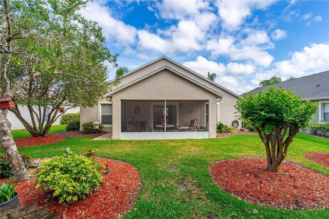 276 Gala Cir, Daytona Beach, FL 32124 - rear view of property with a sunroom, a yard, and stucco siding