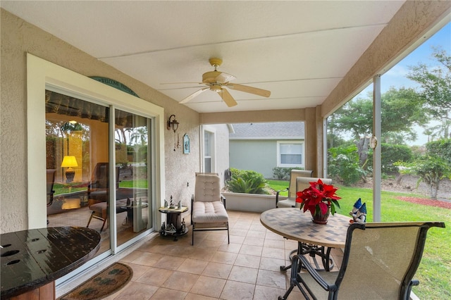 276 Gala Cir, Daytona Beach, FL 32124 - sunroom featuring a ceiling fan, plenty of natural light, tile patterned flooring, and a textured wall