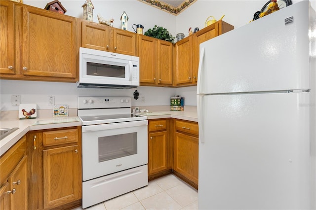 276 Gala Cir, Daytona Beach, FL 32124 - kitchen featuring white appliances, light tile patterned flooring, light countertops, and brown cabinets