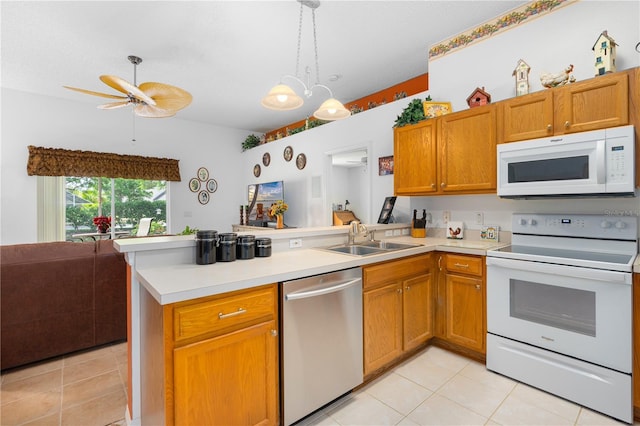 276 Gala Cir, Daytona Beach, FL 32124 - kitchen featuring white appliances, a peninsula, a sink, light tile patterned floors, and light countertops