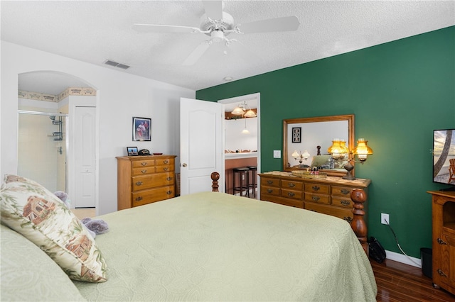 276 Gala Cir, Daytona Beach, FL 32124 - bedroom with wood finished floors, a ceiling fan, arched walkways, baseboards, and a textured ceiling