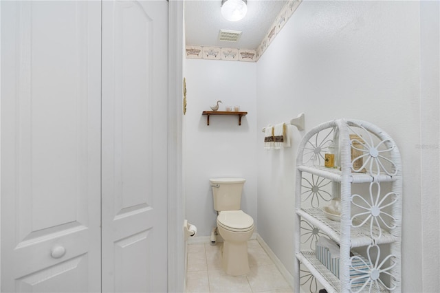 276 Gala Cir, Daytona Beach, FL 32124 - bathroom with toilet, tile patterned flooring, baseboards, and a textured ceiling