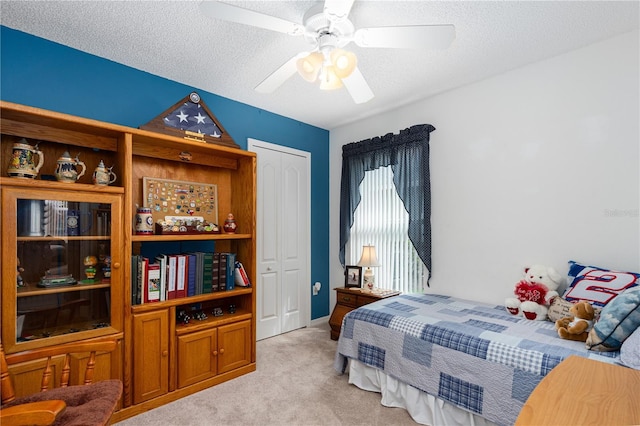 276 Gala Cir, Daytona Beach, FL 32124 - bedroom with light colored carpet, a textured ceiling, a closet, and ceiling fan