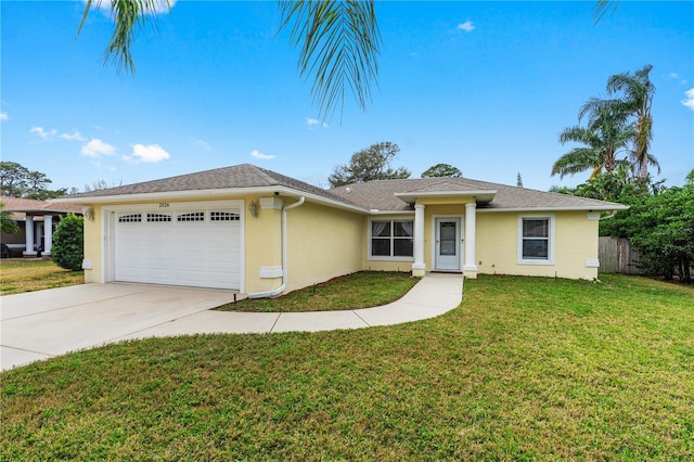 ranch-style home with a garage, fence, a front yard, stucco siding, and driveway