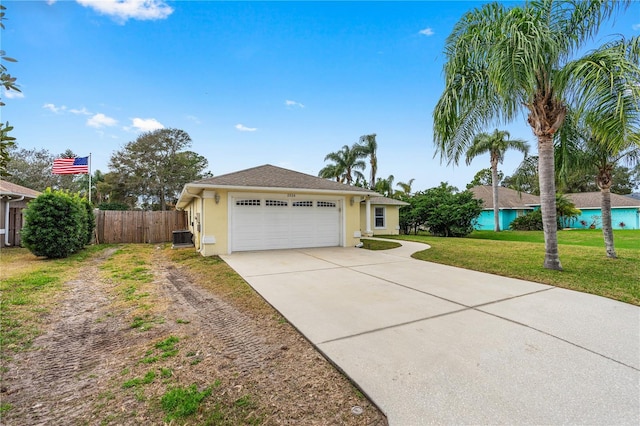 ranch-style house with driveway, fence, a front lawn, an attached garage, and stucco siding