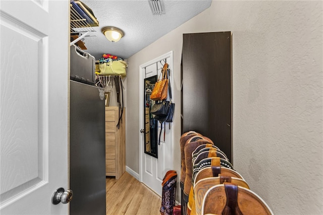 walk in closet featuring visible vents and wood finished floors