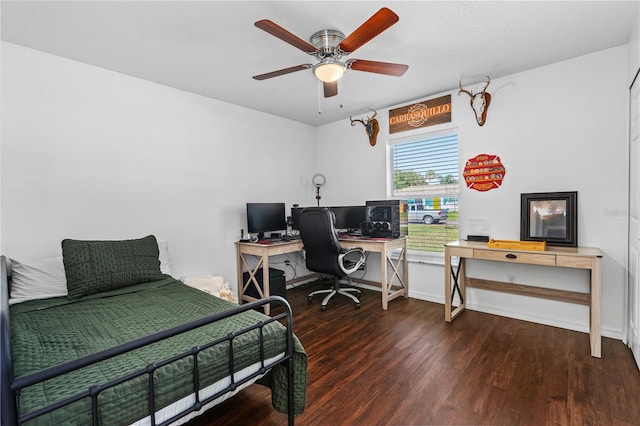 bedroom featuring baseboards, ceiling fan, and wood finished floors