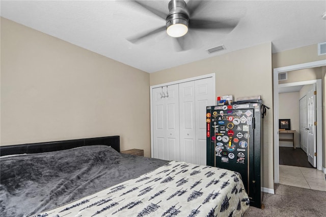 carpeted bedroom featuring a ceiling fan, baseboards, visible vents, and a closet