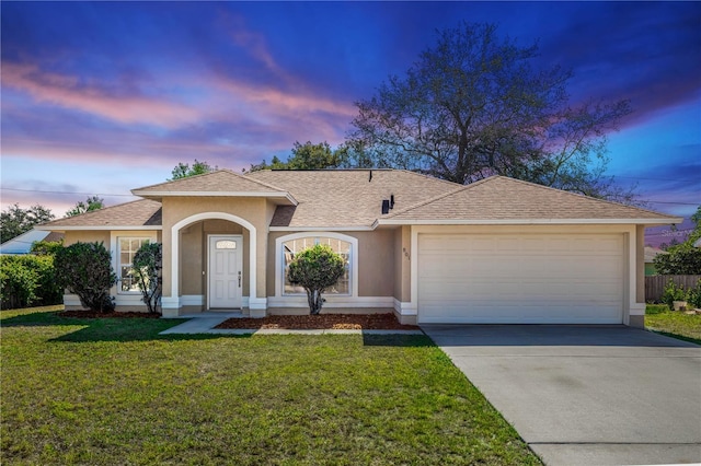 801 Coleman Ave, Deltona, FL 32725 - view of front facade with a garage, stucco siding, a shingled roof, a lawn, and driveway
