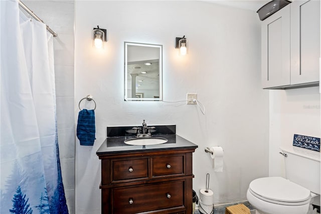 bathroom featuring toilet, curtained shower, and vanity