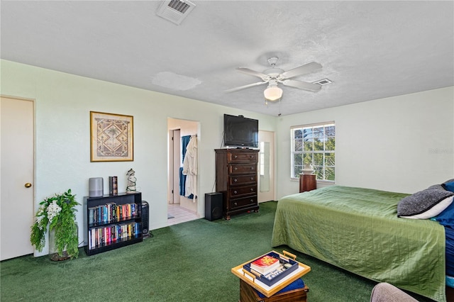 bedroom with visible vents, carpet flooring, and a ceiling fan