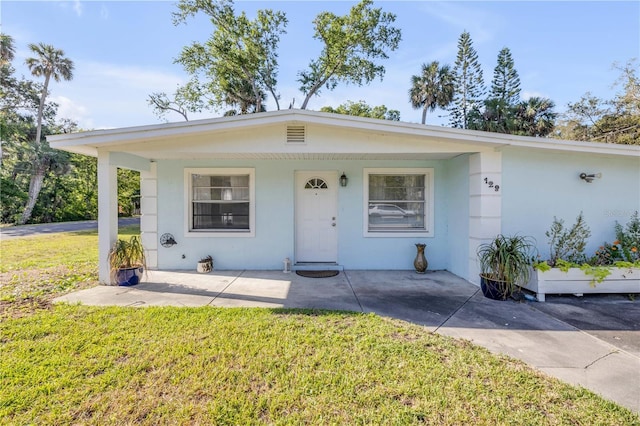 128 Oakridge Ave, Edgewater, FL 32132 - view of front facade with a front lawn and stucco siding