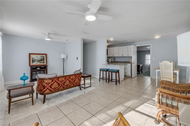 128 Oakridge Ave, Edgewater, FL 32132 - living room with light tile patterned floors, baseboards, and ceiling fan