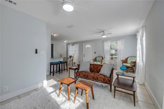 128 Oakridge Ave, Edgewater, FL 32132 - living area with visible vents, baseboards, ceiling fan, and light tile patterned floors