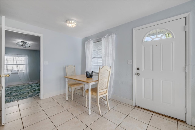128 Oakridge Ave, Edgewater, FL 32132 - dining area with light tile patterned floors, baseboards, and a wealth of natural light