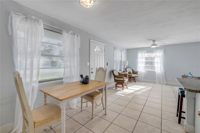 128 Oakridge Ave, Edgewater, FL 32132 - dining space with light tile patterned floors, baseboards, and a ceiling fan