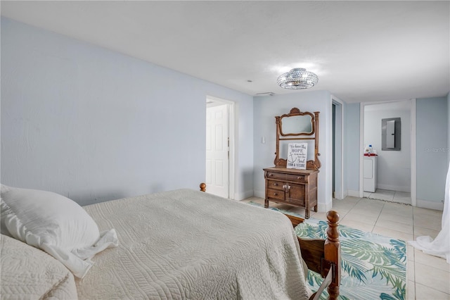 128 Oakridge Ave, Edgewater, FL 32132 - bedroom with light tile patterned floors, baseboards, washer / dryer, and electric panel