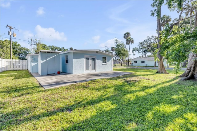128 Oakridge Ave, Edgewater, FL 32132 - rear view of house featuring a patio, a yard, fence, and french doors