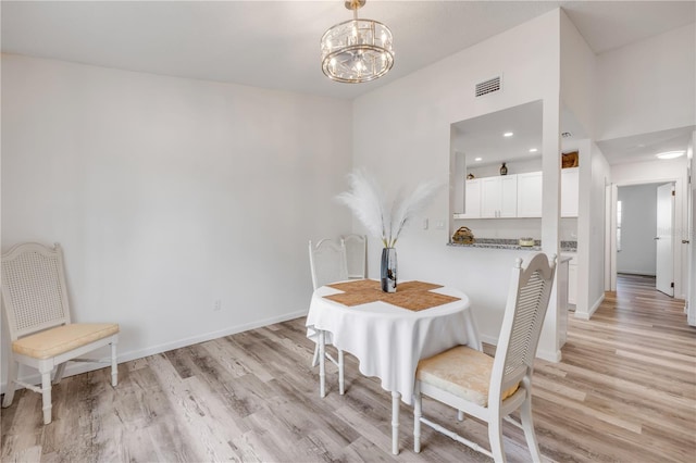 dining space featuring a notable chandelier, recessed lighting, baseboards, light wood-type flooring, and visible vents