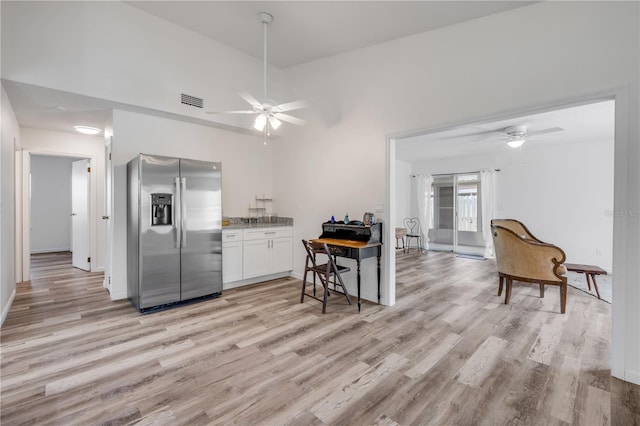 kitchen with stainless steel fridge, a ceiling fan, visible vents, and light wood-type flooring