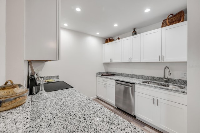 kitchen with light stone counters, a sink, dishwasher, recessed lighting, and white cabinetry