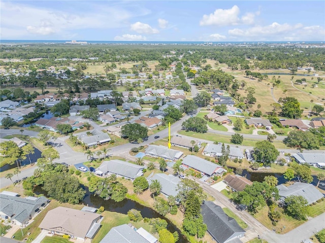 drone / aerial view with a residential view and a water view