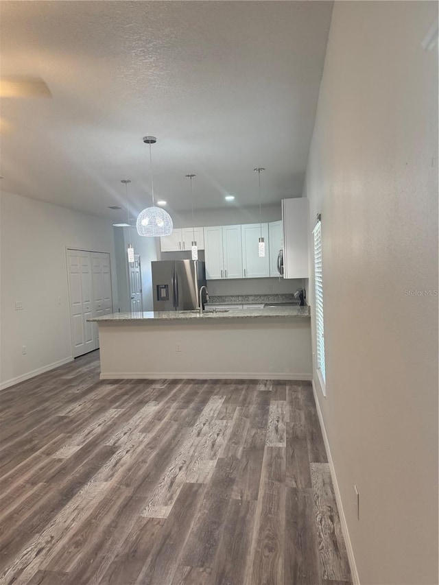 926 Clover St, Deland, FL 32720 - kitchen with a peninsula, white cabinets, appliances with stainless steel finishes, and dark wood-style floors