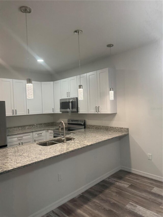 926 Clover St, Deland, FL 32720 - kitchen with white cabinets, stainless steel appliances, dark wood finished floors, and a sink