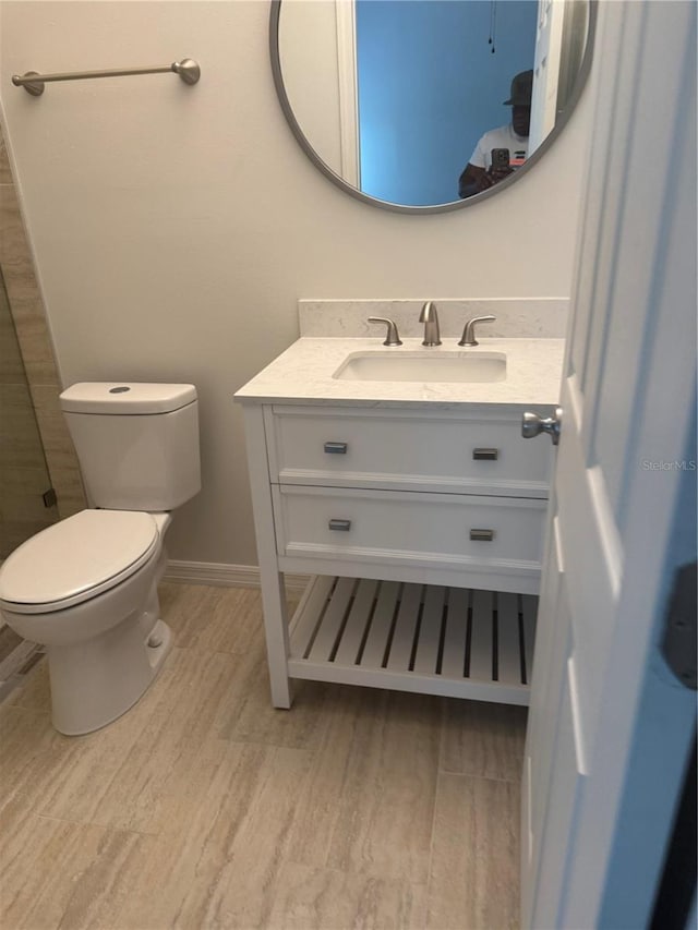 926 Clover St, Deland, FL 32720 - bathroom featuring toilet, baseboards, wood finished floors, and vanity
