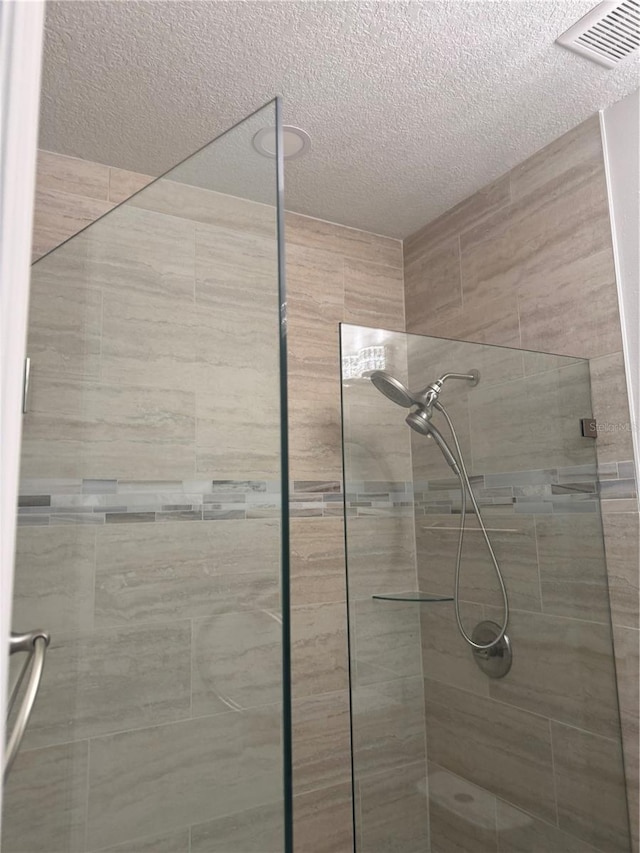 926 Clover St, Deland, FL 32720 - bathroom featuring a textured ceiling, visible vents, and a shower stall