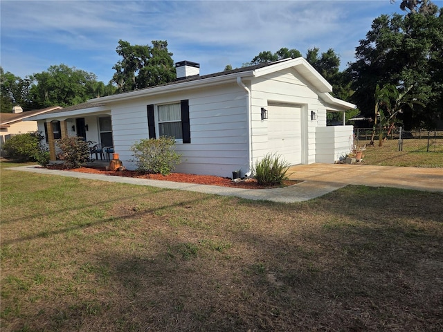 view of front facade featuring fence, a chimney, a front lawn, and a garage