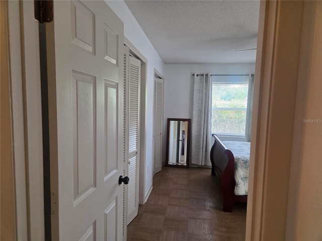 hallway featuring a textured ceiling