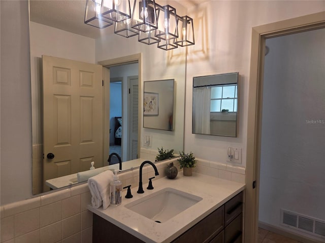 bathroom featuring visible vents and vanity