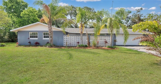 88 Valencia Dr, Ormond Beach, FL 32176 - ranch-style home with a front lawn, an attached garage, and driveway