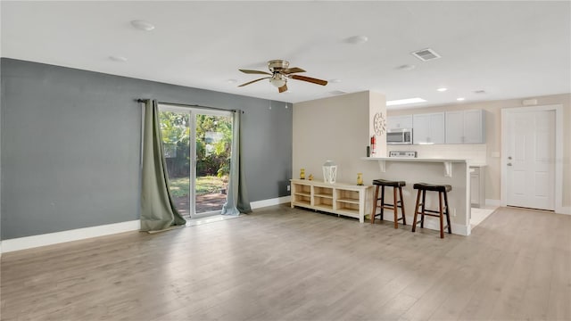 88 Valencia Dr, Ormond Beach, FL 32176 - living room with baseboards, light wood-style flooring, a ceiling fan, and recessed lighting