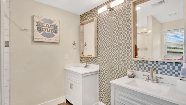 88 Valencia Dr, Ormond Beach, FL 32176 - bathroom with two vanities, baseboards, and a shower