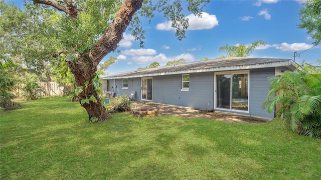 88 Valencia Dr, Ormond Beach, FL 32176 - back of property with a patio and an outdoor fire pit