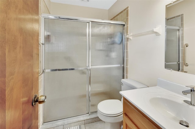 bathroom with vanity, toilet, tile patterned flooring, and a stall shower