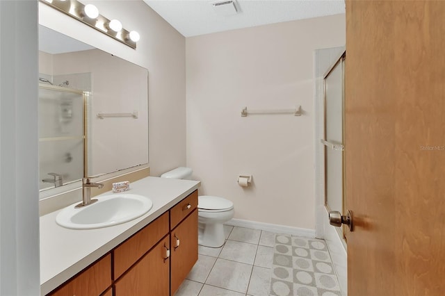 bathroom featuring visible vents, vanity, tile patterned floors, baseboards, and toilet