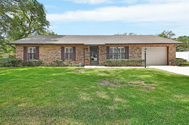 ranch-style house with brick siding, an attached garage, a front yard, and concrete driveway