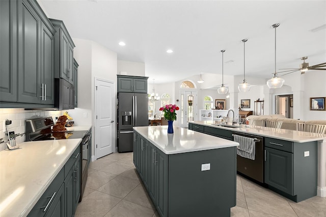 2814 S Asciano Ct, New Smyrna Beach, FL 32168 - kitchen with a sink, open floor plan, black appliances, light countertops, and an island with sink